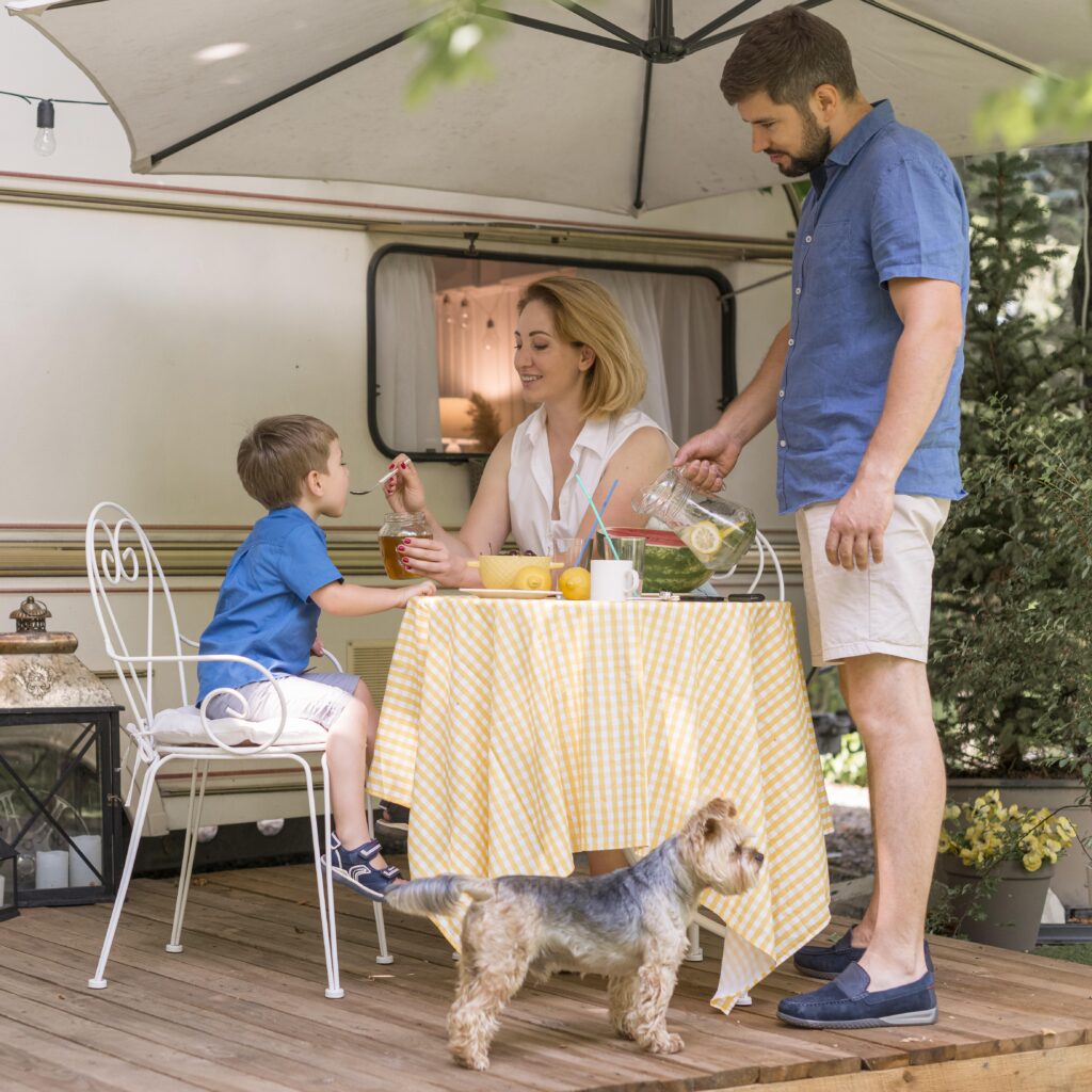 family-taking-lunch-outside-caravan